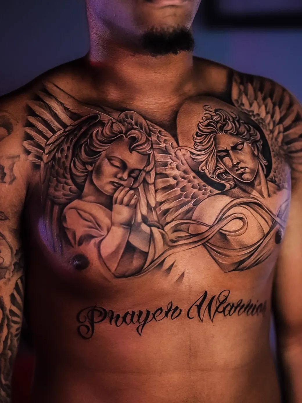 Guardian angels with "Prayer Warrior" script — black & grey realism tattoo on the chest, by Foenix Ink, Hollywood FL (session 1)