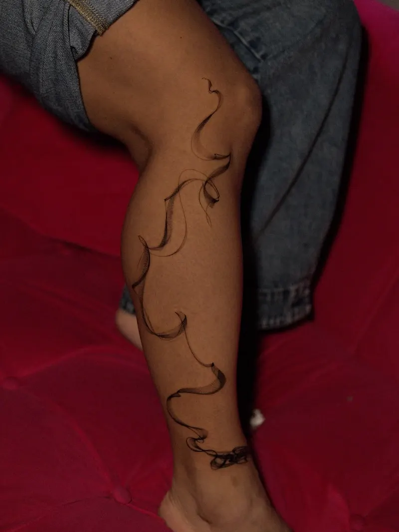 Minimal vine — fine line tattoo on the calf, by Foenix Ink, Hollywood FL